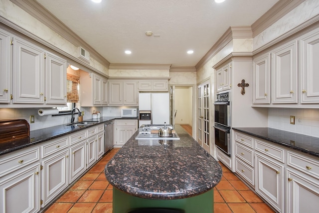 kitchen featuring light tile patterned flooring, tasteful backsplash, sink, a center island, and black appliances