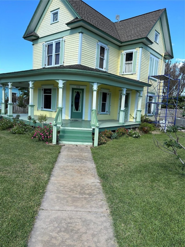 victorian house with covered porch and a front yard