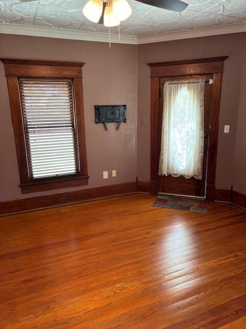 foyer entrance featuring crown molding, ceiling fan, and wood-type flooring