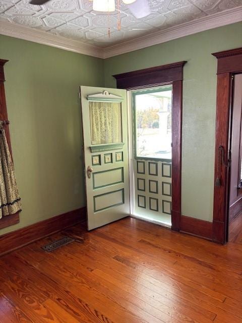 entrance foyer with wood-type flooring and ornamental molding