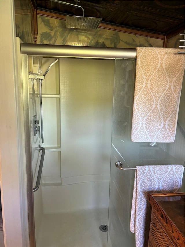 bathroom featuring a shower with shower door