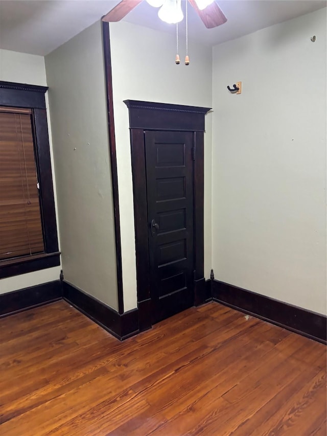 spare room featuring ceiling fan and dark hardwood / wood-style flooring