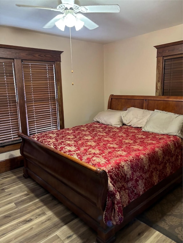 bedroom with hardwood / wood-style flooring and ceiling fan