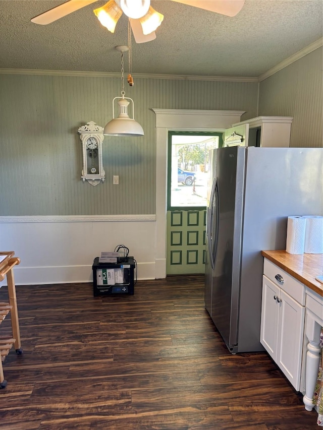 kitchen featuring stainless steel refrigerator, ceiling fan, hanging light fixtures, dark hardwood / wood-style floors, and white cabinets