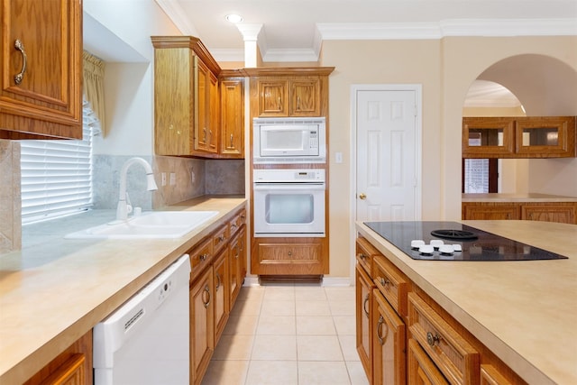 kitchen featuring sink, backsplash, white appliances, light tile patterned flooring, and ornamental molding