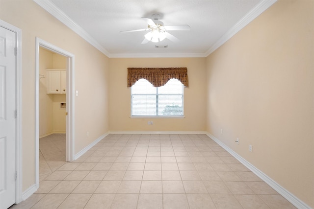 tiled empty room with ceiling fan and ornamental molding