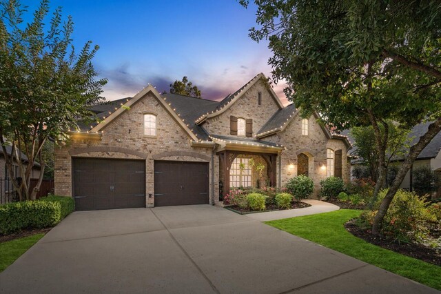 french country home featuring a garage