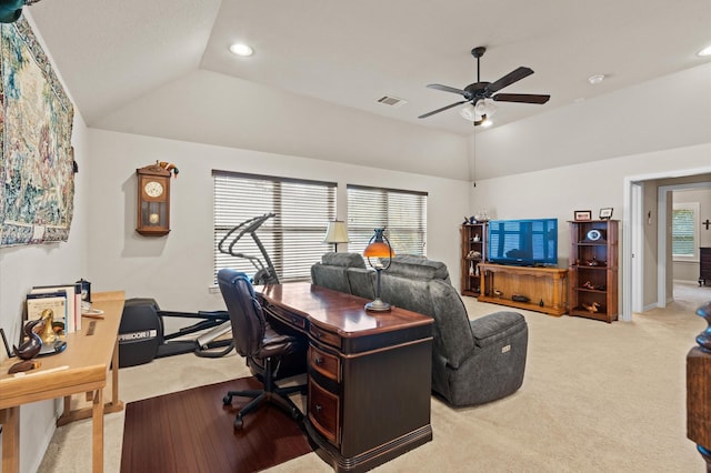 carpeted home office with ceiling fan and vaulted ceiling