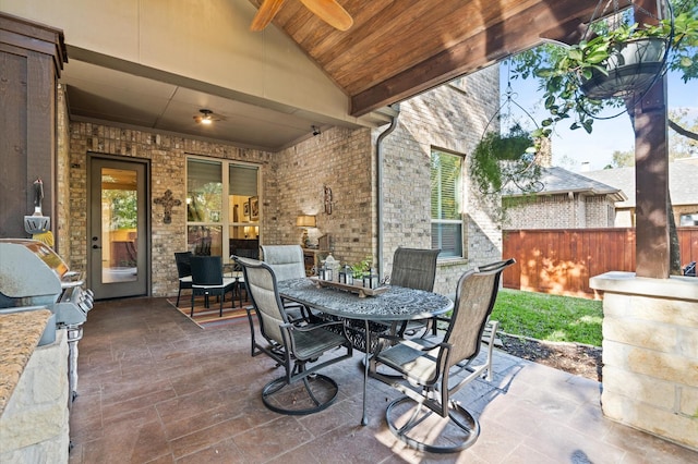 view of patio with an outdoor kitchen, ceiling fan, and a grill