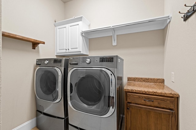 laundry area featuring cabinets and independent washer and dryer