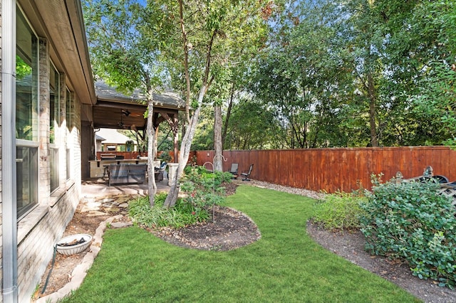 view of yard featuring ceiling fan and a patio area