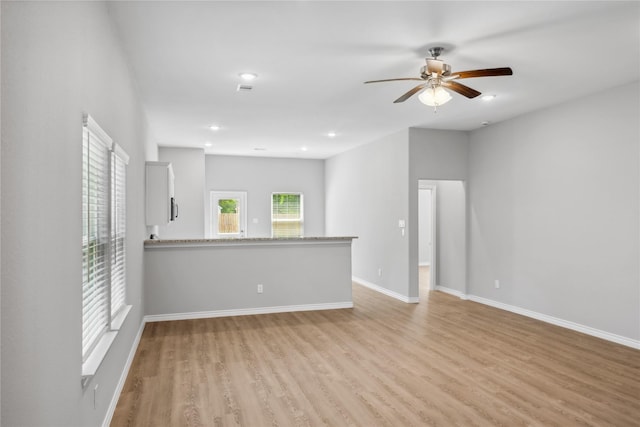 empty room featuring light wood-type flooring and ceiling fan