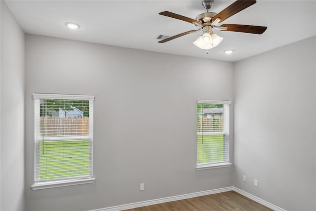 spare room with ceiling fan and light wood-type flooring