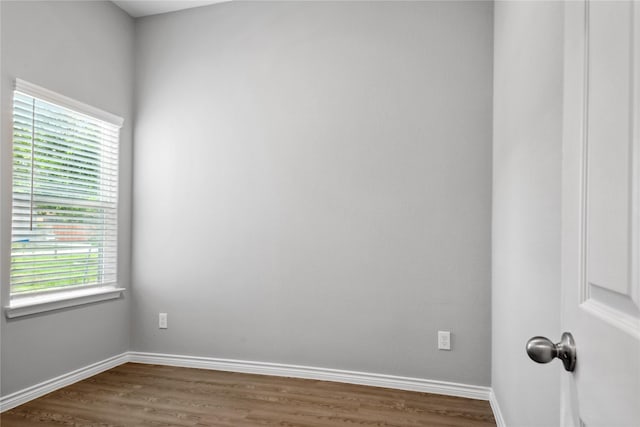 empty room with dark hardwood / wood-style flooring