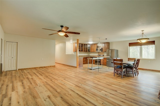 living room with ceiling fan and light hardwood / wood-style floors