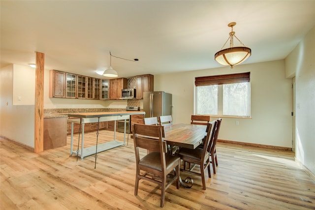 dining area featuring light wood-type flooring