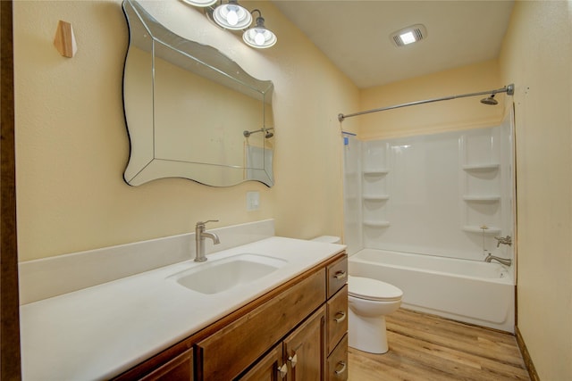 full bathroom with vanity, toilet, tub / shower combination, and hardwood / wood-style floors