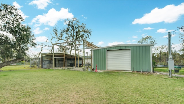 view of outdoor structure featuring a garage and a lawn