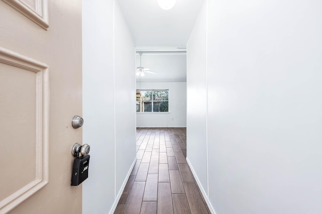 hallway with hardwood / wood-style floors