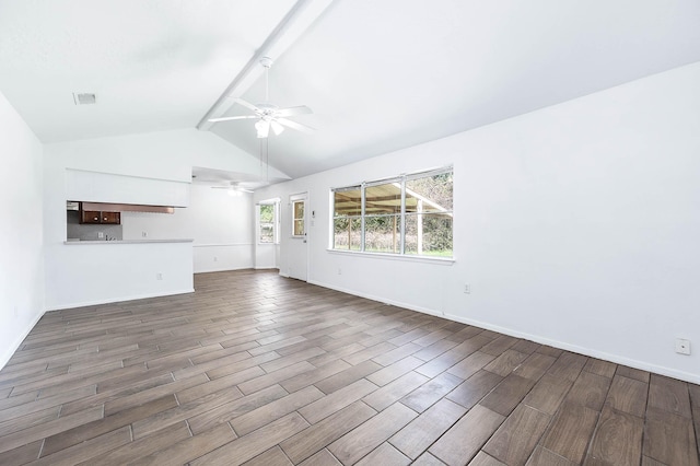 unfurnished living room with beam ceiling, dark hardwood / wood-style floors, high vaulted ceiling, and ceiling fan