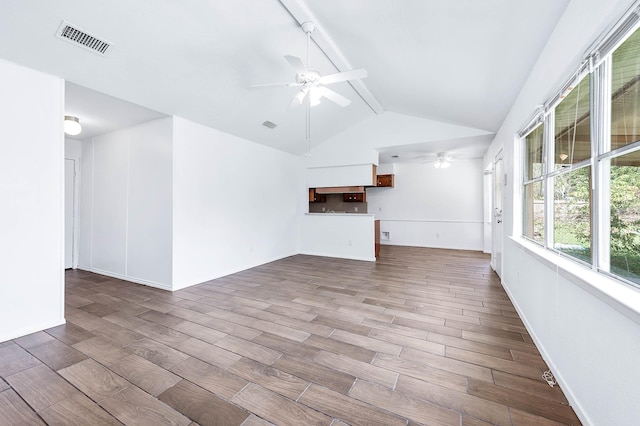 unfurnished living room featuring vaulted ceiling with beams, ceiling fan, and light wood-type flooring