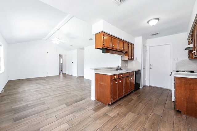 kitchen with sink, black dishwasher, stove, hardwood / wood-style floors, and lofted ceiling