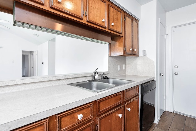 kitchen featuring dishwasher, dark hardwood / wood-style floors, tasteful backsplash, and sink