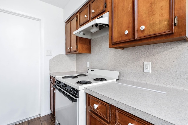 kitchen featuring decorative backsplash, electric range, and hardwood / wood-style flooring