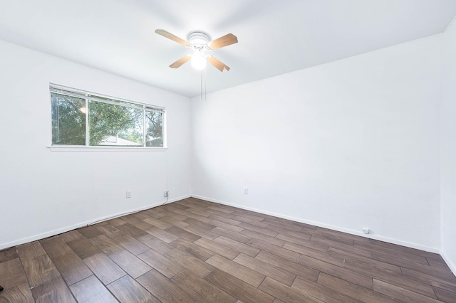 empty room with ceiling fan and dark wood-type flooring