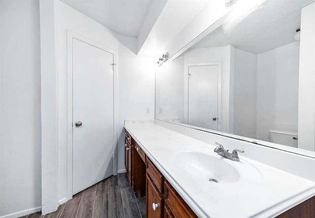 bathroom featuring hardwood / wood-style floors, vanity, and toilet