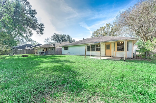 rear view of property featuring a yard and a patio