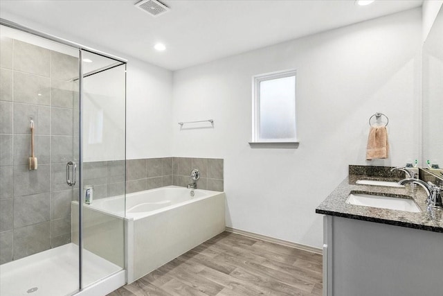 bathroom featuring vanity, shower with separate bathtub, and hardwood / wood-style flooring