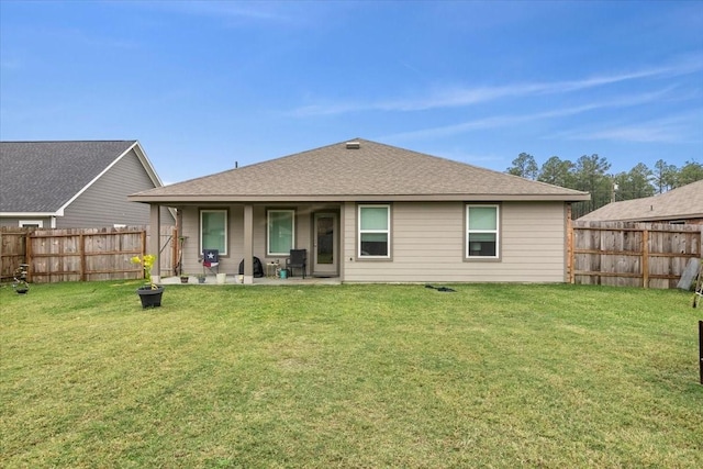 back of property with a lawn and a patio area