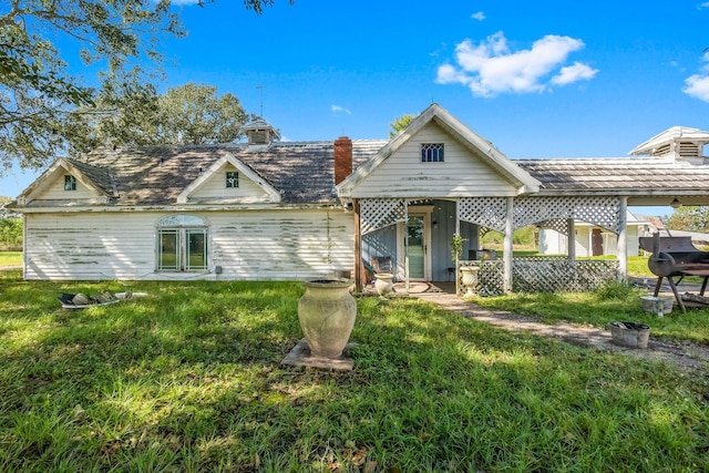 back of house with a yard