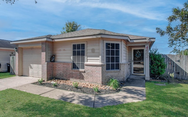 view of front of house with a front yard and a garage