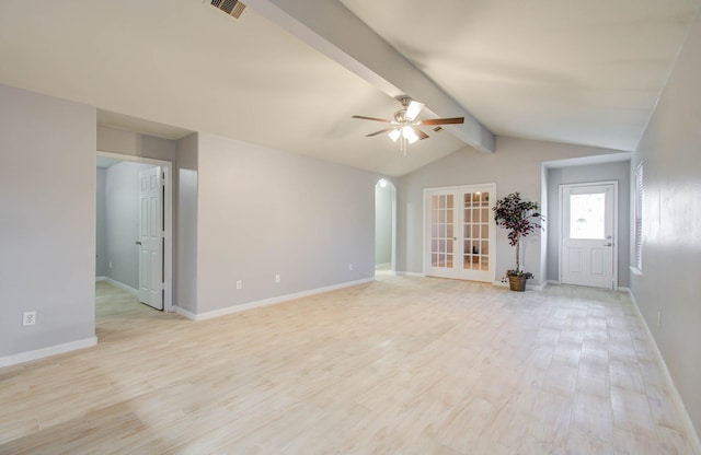 unfurnished living room with lofted ceiling with beams, ceiling fan, light wood-type flooring, and french doors