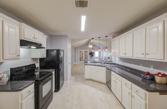 kitchen featuring kitchen peninsula, vaulted ceiling, sink, black appliances, and pendant lighting