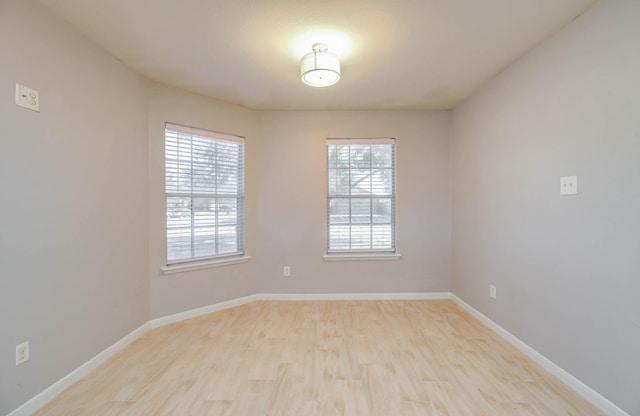 spare room with a healthy amount of sunlight and light wood-type flooring