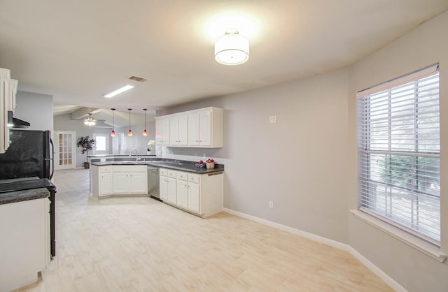 kitchen featuring kitchen peninsula, white cabinets, hanging light fixtures, and dishwasher