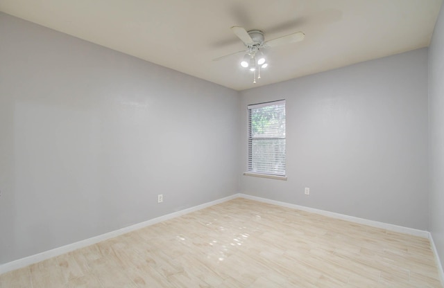 empty room with ceiling fan and light wood-type flooring