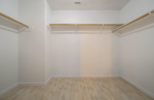 walk in closet featuring light hardwood / wood-style flooring