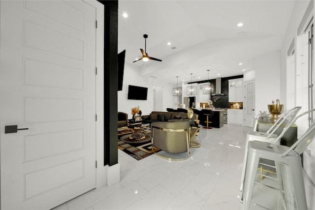 living room featuring vaulted ceiling and ceiling fan