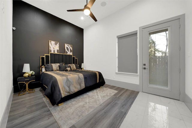 bedroom with access to outside, light hardwood / wood-style flooring, and ceiling fan