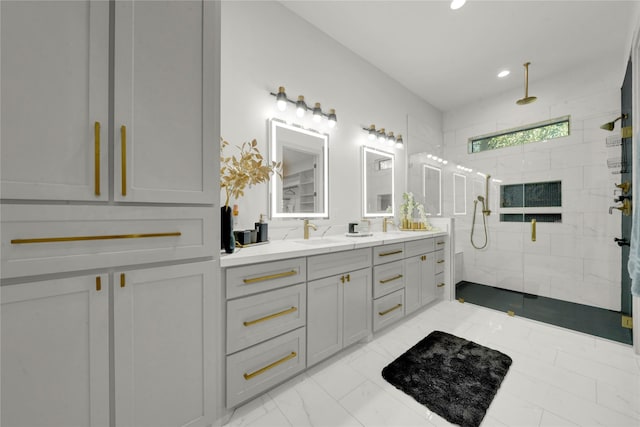 bathroom featuring tiled shower and vanity