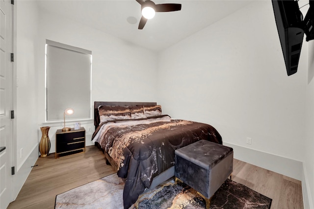 bedroom featuring light wood-type flooring, ceiling fan, and lofted ceiling