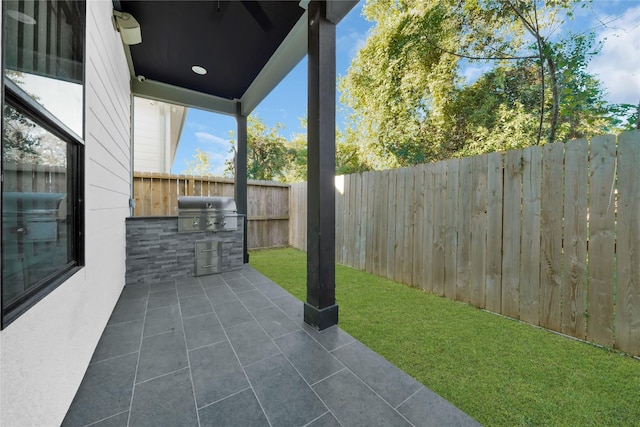 view of patio / terrace featuring a grill and exterior kitchen