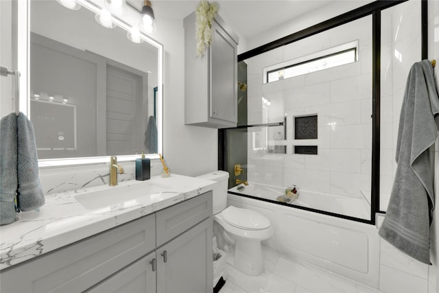 full bathroom with vanity, toilet, and bath / shower combo with glass door