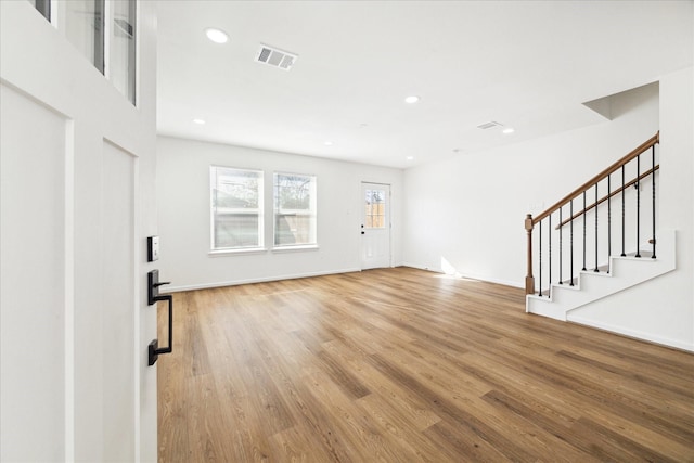 unfurnished living room featuring light hardwood / wood-style floors