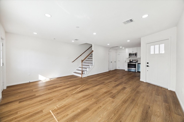 unfurnished living room with light hardwood / wood-style flooring