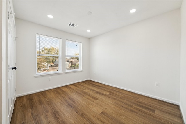 spare room with dark hardwood / wood-style flooring